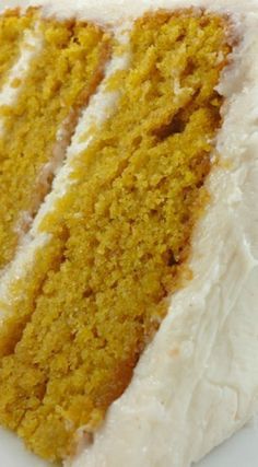 a slice of carrot cake with white frosting on a plate, ready to be eaten