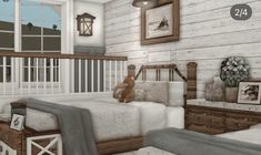 a teddy bear sitting on top of a bed in a room with white walls and wooden floors