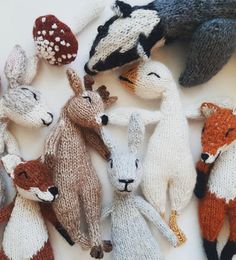 several knitted animals laying next to each other