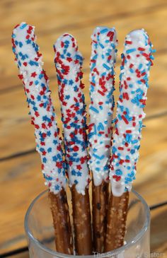 some pretzels with sprinkles in a glass on a wooden table