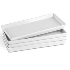 three white plates stacked on top of each other in front of a white background,