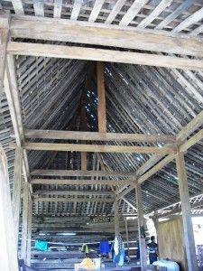 the inside of a building with wooden beams and roof rafters on top of it