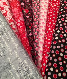 many different colored and patterned fabrics are arranged together