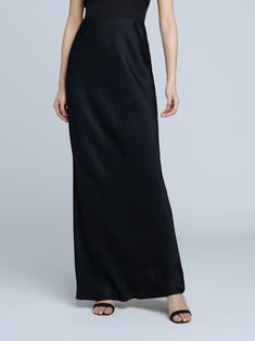 A stunning, understated maxi skirt in pure black. Bias-cut, silk-like fabric falls in a subtle, lustrous cling over the figure, enhancing and elongating the silhouette. Smooth elastic waist with no closures. Full Length Satin Finish Maxi Dress, Silk Floor-length Bias Cut Maxi Skirt, Elegant Floor-length Satin Skirt, Silk Bias Cut Floor-length Maxi Skirt, Silk Bias-cut Floor-length Maxi Skirt, Elegant Solid Silk Maxi Dress, Elegant Satin Maxi Skirt With Bias Cut, Elegant Satin Bias Cut Maxi Skirt, Solid Silk Bias Cut Maxi Dress