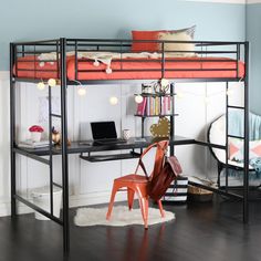 a bunk bed with desk underneath it in a room that has hardwood floors and blue walls