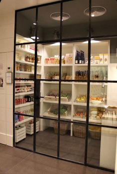 the inside of a store with lots of shelves full of food and drinks on display