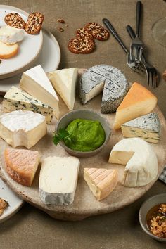 cheeses and crackers are arranged on a platter