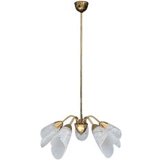 an antique brass chandelier with five glass flowers hanging from it's center