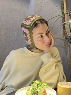 a woman sitting at a table with a plate of food