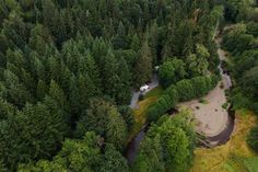 an aerial view of a wooded area with a river running through it