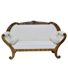 a white couch sitting on top of a wooden frame