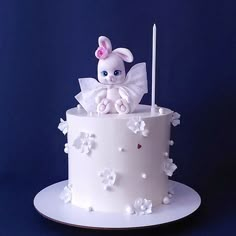 a white cake topped with a bunny sitting on top of it