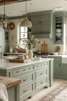 a kitchen filled with lots of green cabinets