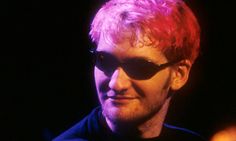 a man with pink hair and sunglasses on