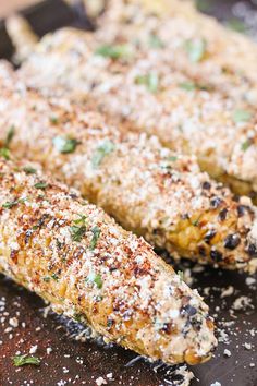 grilled corn on the cob with lime wedges and parmesan cheese