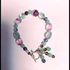 This Is A Gorgeous New Artisan Crafted 6” Pastel Green And Purple Glass Beaded Bracelet With Toggle Clasp! You Can Make A Fashion Statement In Perfect Style! You’re Going To Get Lots Of Compliments! Comes Already Gift Wrapped And In A Fancy Gold Gift Box! Makes An Excellent Gift For Yourself Or Your Loved Ones! Comes From A Smoke And Pet Free Environment. Please Ask Any Questions You Have. Offers Welcome! Thank You For Shopping With Us At Nancy’s Creative Treasures! Adjustable Multicolor Amethyst Bracelet, Adjustable Multicolor Amethyst Bracelets, Handmade Adjustable Lavender Crystal Bracelet, Handmade Multicolor Amethyst Bracelets, Adjustable Handmade Lavender Crystal Bracelet, Adjustable Green Amethyst Jewelry, Adjustable Purple Beaded Bracelets With Lobster Clasp, Pastel Green And Purple, Glass Beaded Bracelet