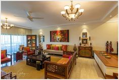 a living room filled with lots of furniture next to a wall mounted painting on the wall