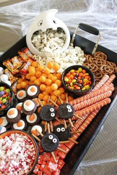 a tray filled with halloween treats and snacks