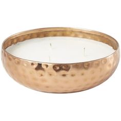 a large metal bowl with a white candle in the middle and a gold rim around it