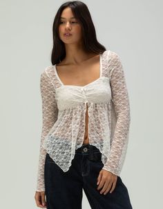 West Of Melrose Lace Fly Away Top. This Women's Lace Flyaway Top Exudes Effortless Elegance With Its Delicate Lace Fabric And Flowing Silhouette. The Open, Flyaway Design Creates A Graceful, Layered Effect, Perfect For Adding A Touch Of Sophistication To Any Outfit. Square Neckline. Double Lined Bodice. Cinched Detailing At Chest. Long Sleeves. 98% Nylon, 2% Spandex. Hand Wash. Imported. Model Is Wearing A Size Small. Model Measurements:height: 5'7" Bust: 32abwaist: 23"hips: 34"