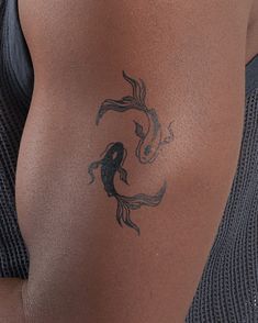 a woman with a tattoo on her stomach has a koi fish drawn on it