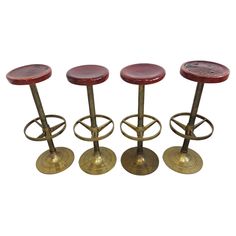 three stools with foot rests on top of each other in the shape of barstools