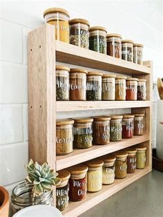 a wooden spice rack filled with lots of spices