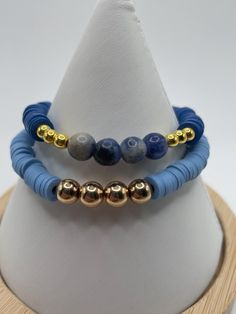 Two pretty clay heishi bracelets.  Blue clay beads. Accented with blue marble glass beads and golden beads. Strong stretchy string. Sizes 6.5-7 Bracelets Heishi, Heishi Bracelets, Blue Clay, Golden Beads, Blue Marble, Clay Beads, Glass Beads, Jewelry Bracelets, Beaded Bracelets