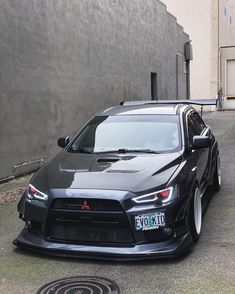 a black car parked in front of a building