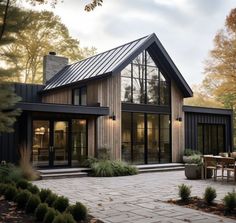 a modern house in the woods with lots of windows