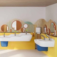 a bathroom with three sinks and several mirrors on the wall, all in different colors