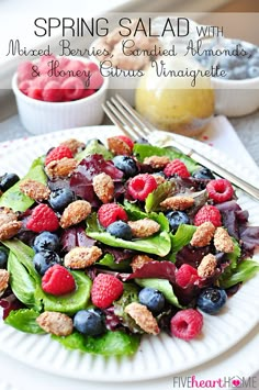 a white plate topped with salad and berries