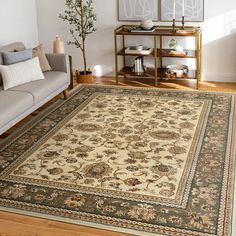 a living room filled with furniture and a rug on top of a hard wood floor