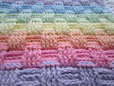 a crocheted blanket with different colors on it