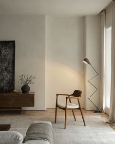 a living room filled with furniture and a painting on the wall