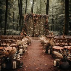 an outdoor ceremony setup with chairs and lights in the woods, decorated with pamodia