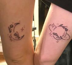 two people with matching tattoos on their legs, one is holding the other's hand