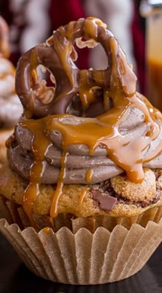 a cupcake with chocolate and caramel drizzled on top