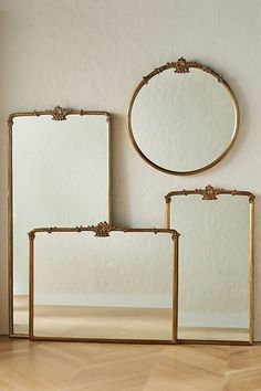 three mirrors sitting on top of a wooden floor