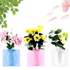 three vases filled with different colored flowers on a white background and one has green leaves