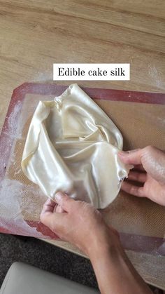 someone is kneading some food on a table with the words edible cake silk