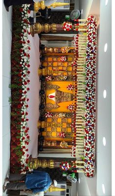 the interior of a temple decorated with colorful garlands