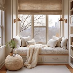 a window seat with pillows and blankets on it