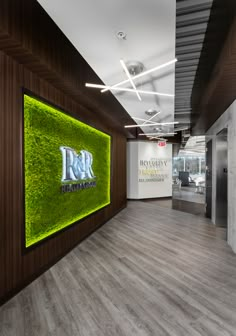 the interior of an office with moss growing on the wall and wood paneled walls