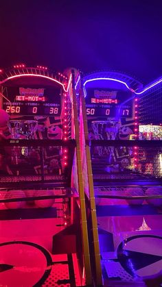 an amusement park at night lit up with neon lights