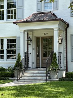 the front door of a large white house