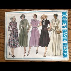 three women's dress patterns from the 1950's and 1960s's on a wooden table