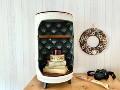 an old fashioned stove sitting on top of a wooden table next to a pair of binoculars