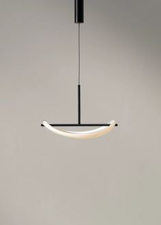 a black and white light hanging from a ceiling