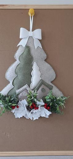 a paper christmas tree hanging on a wall